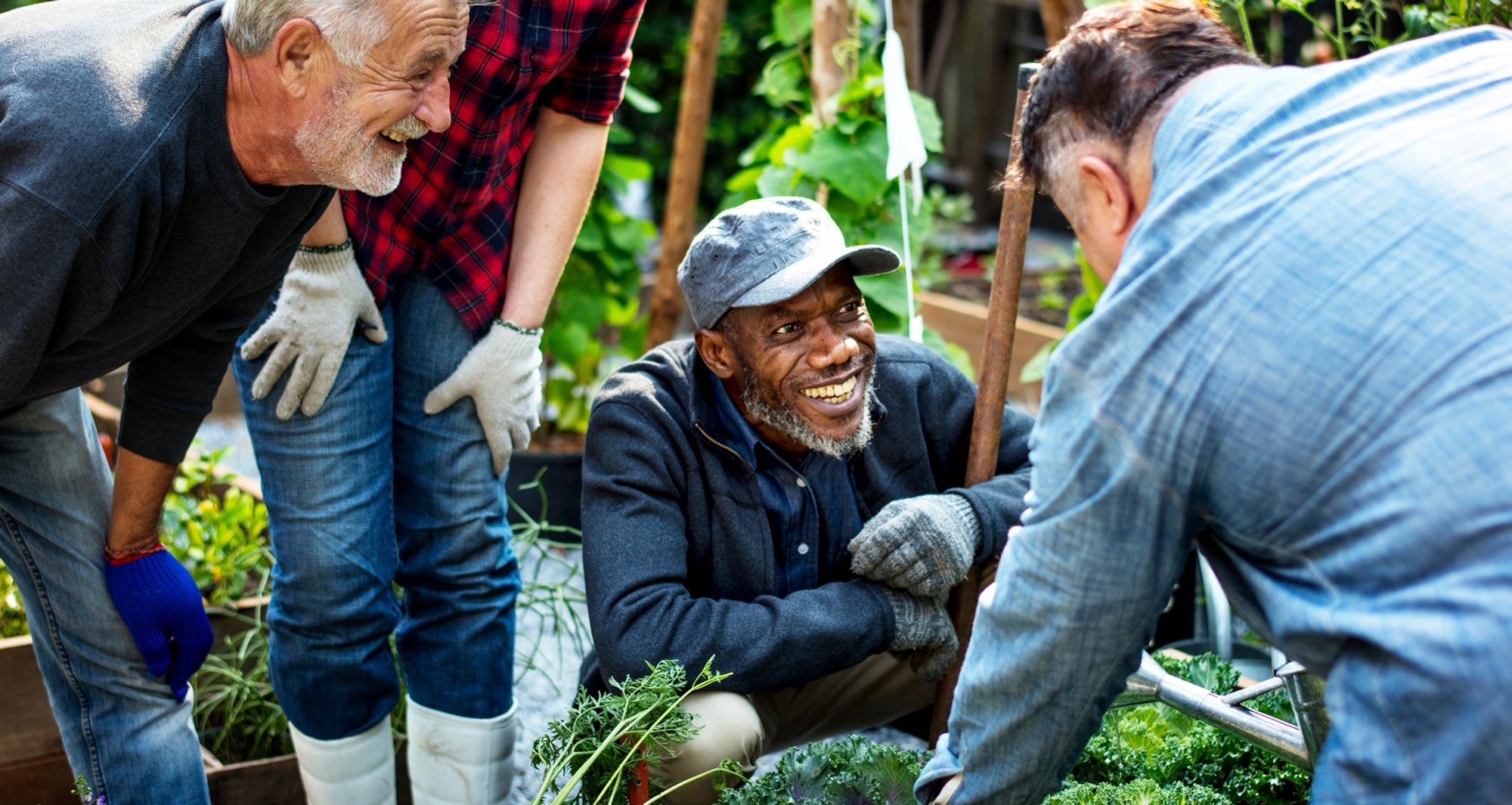 group of men laughing around local produce