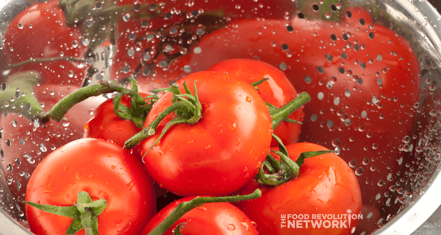 Washing produce - tomatoes - in a colander 