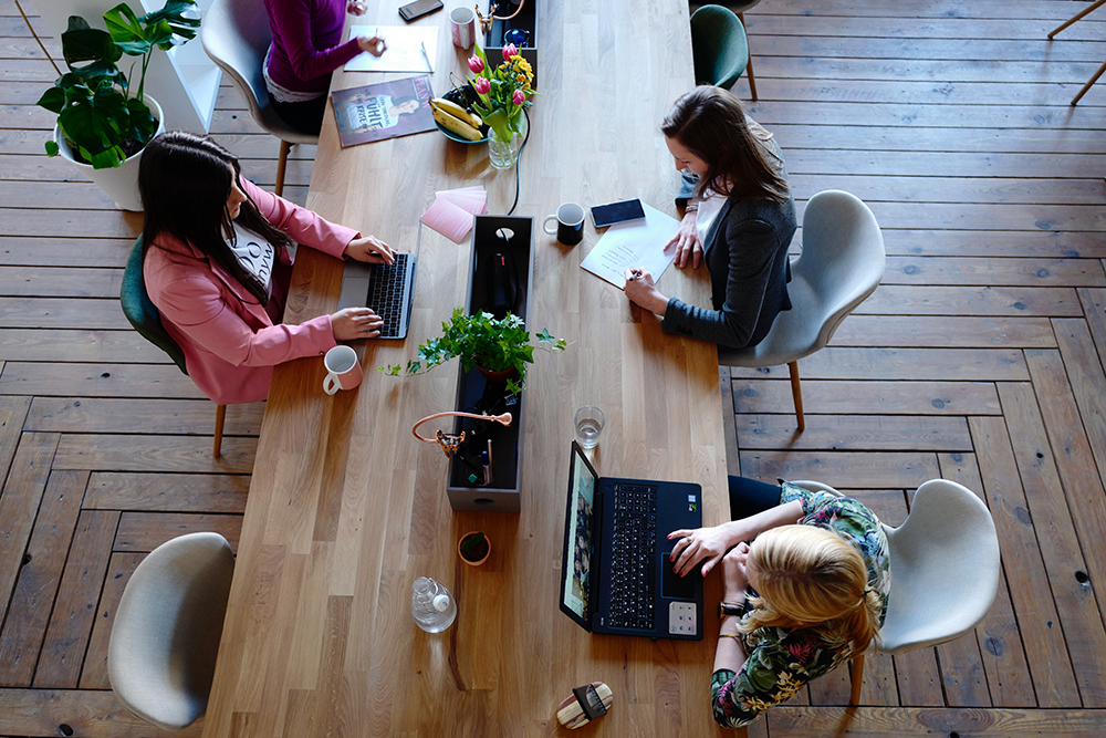 people working around a desk in an office