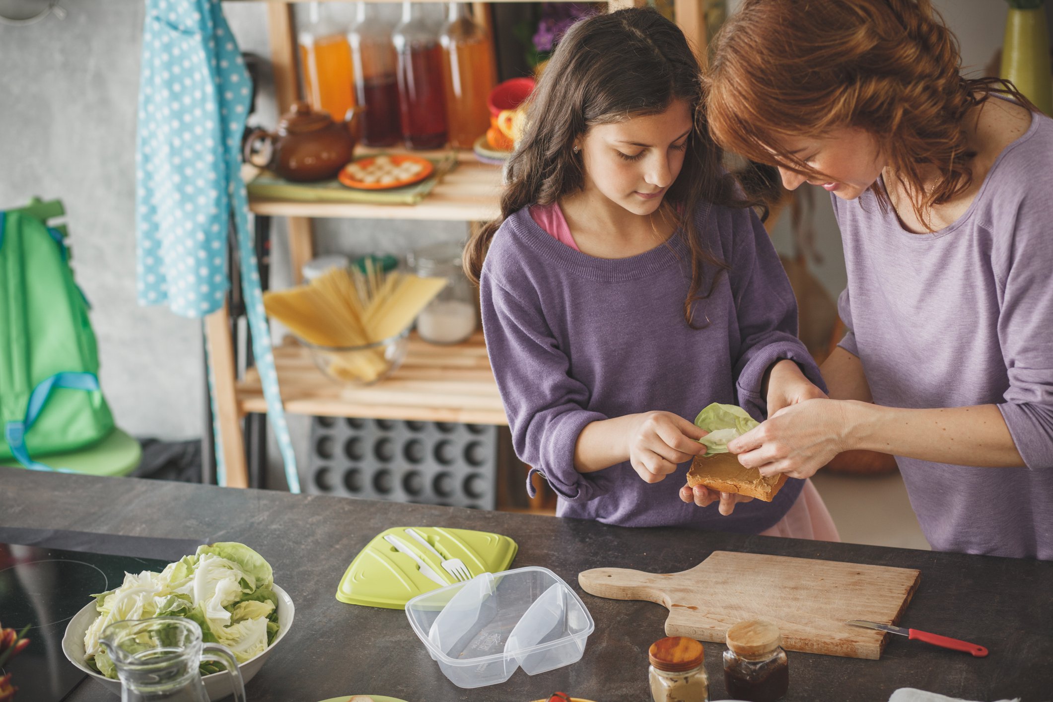 Mother and daughter preparing lunch in the kitchen