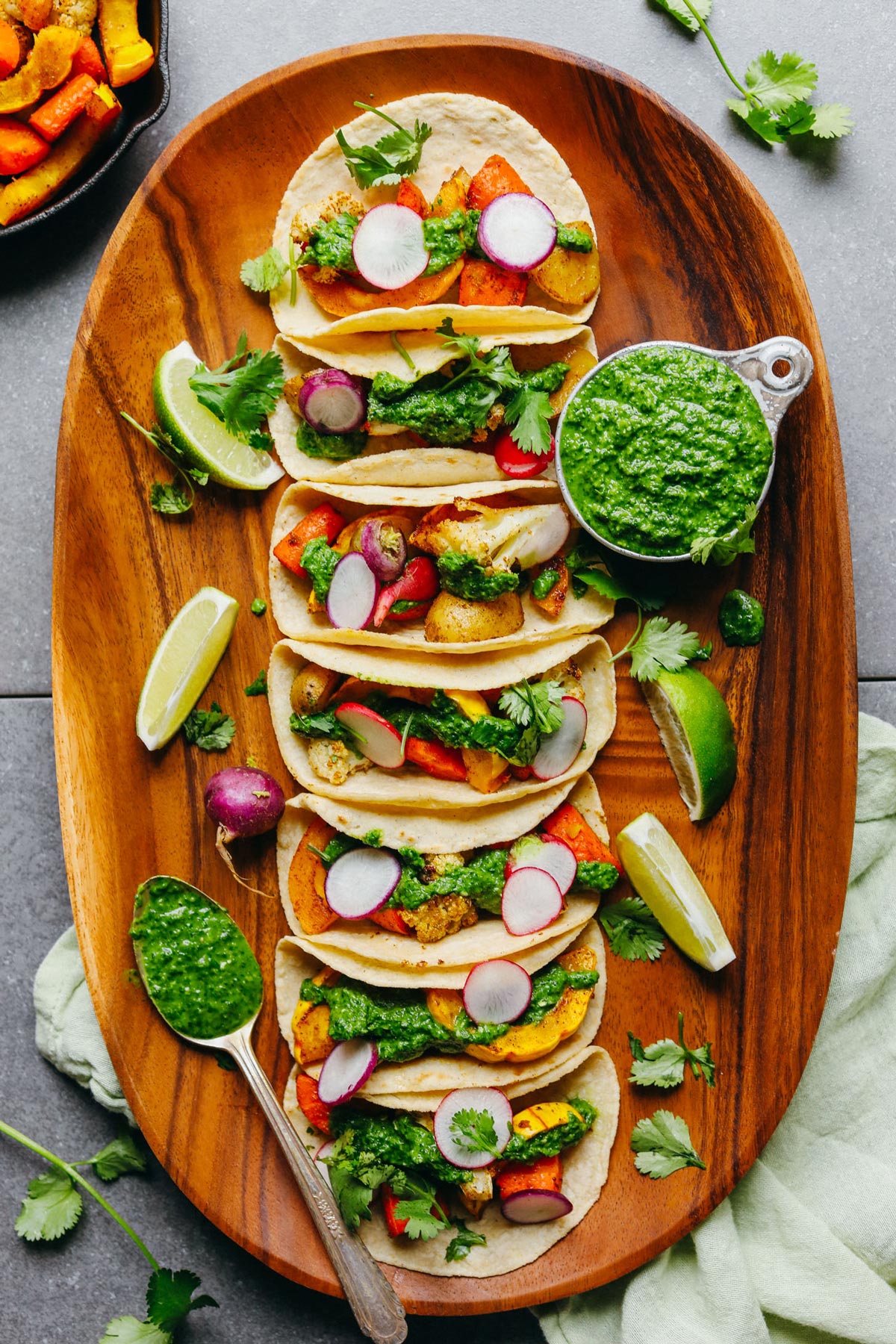 roasted vegetables with chimichurri on wooden plate