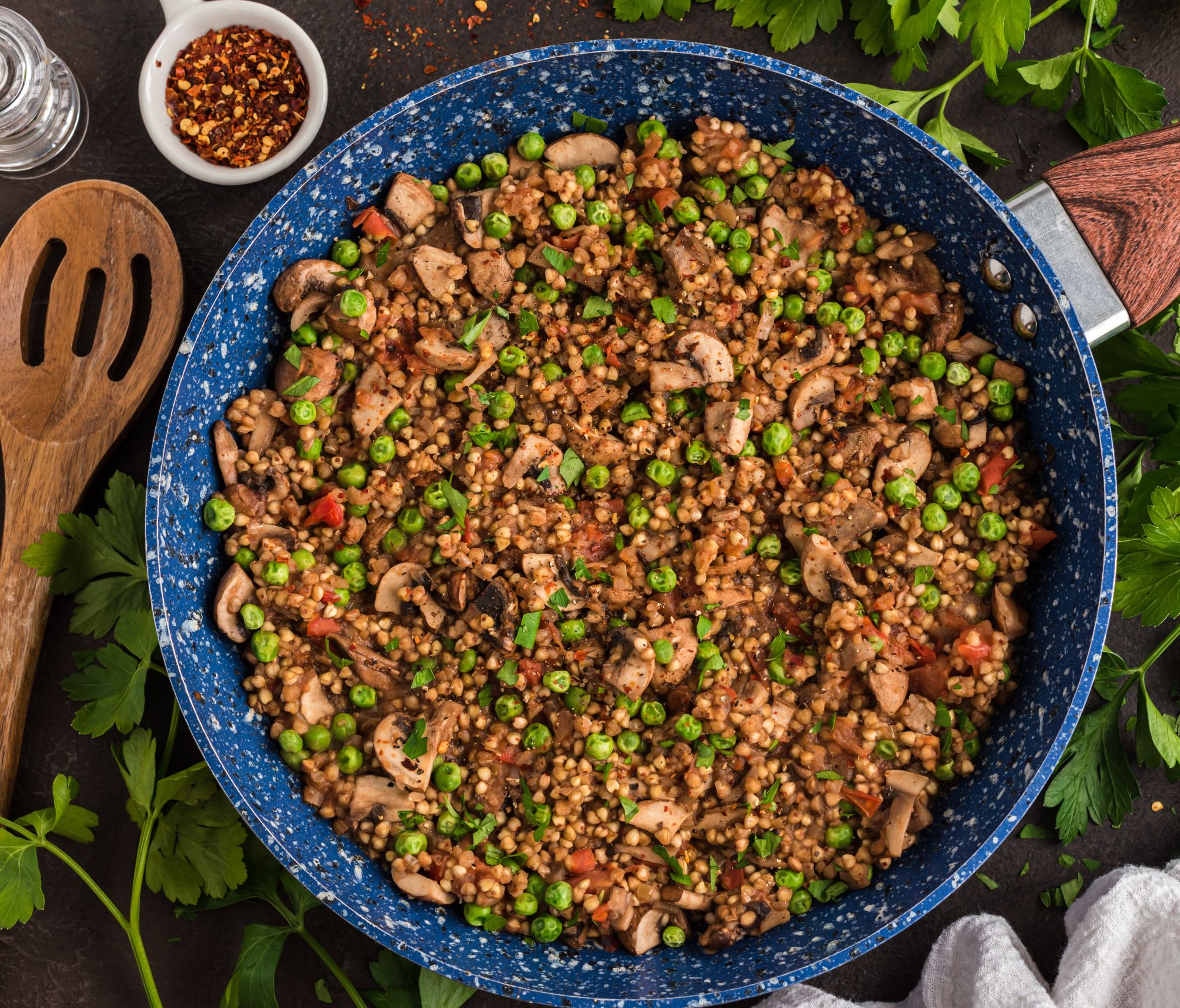 Buckwheat Risotto with Mushrooms and Peas in a frying pan