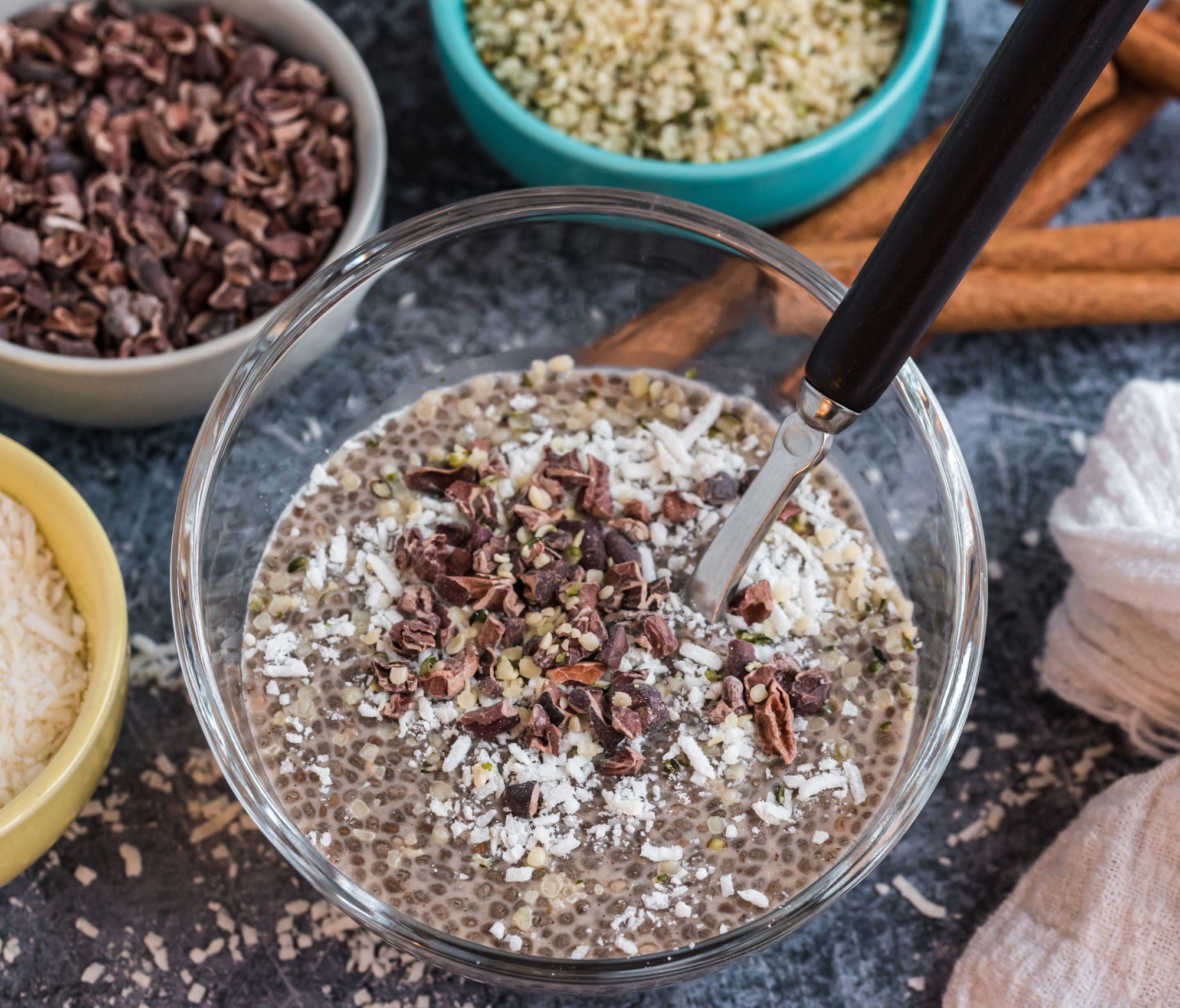 Creamy Vanilla Cinnamon Chia Pudding surrounded by multiple spices and herbs