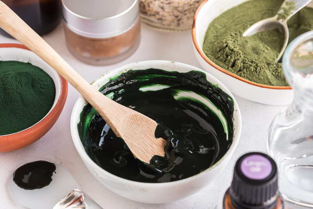 DIY Matcha Spirulina Face Mask in a bowl surrounded by ingredients