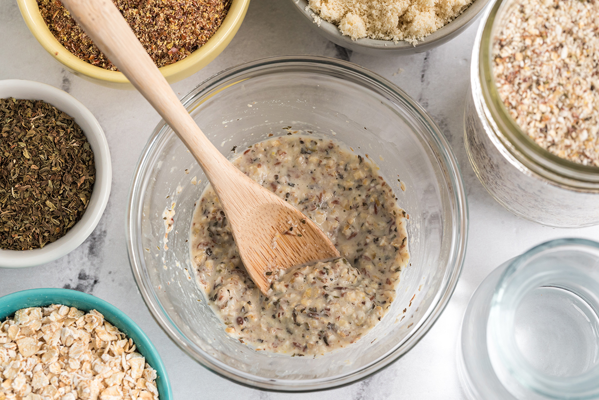 DIY Soothing Oat and Almond Face Scrub in a bowl surrounded by ingredients