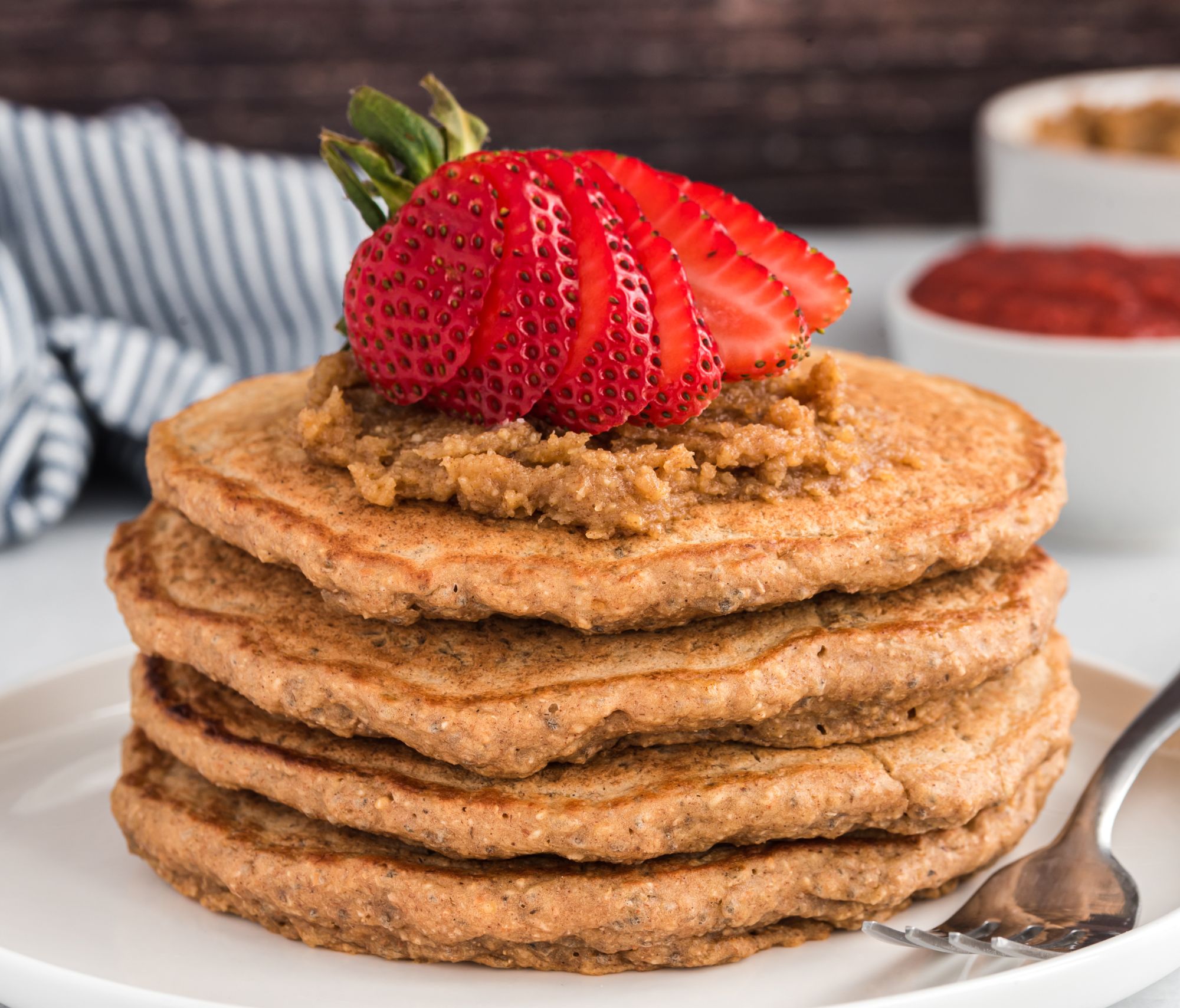 Fluffy Buckwheat Chia Pancakes on a plate on top of a dining room table