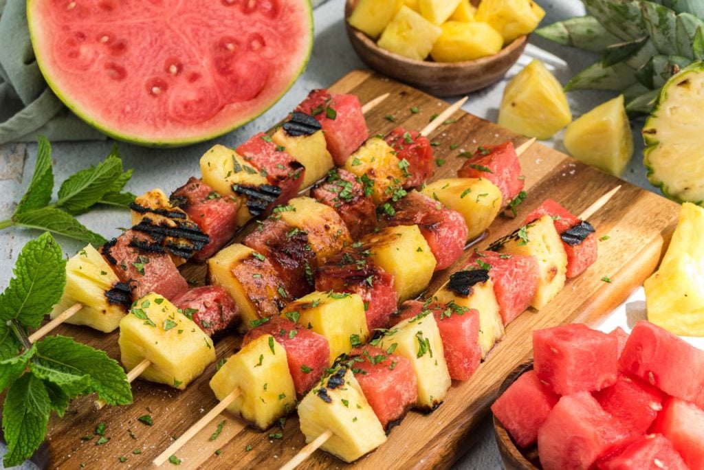 grilled watermelon and pineapple skewers on board