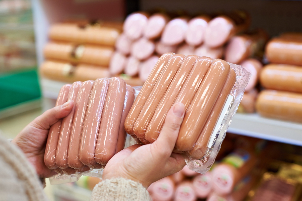 Choosing hot dogs at the store