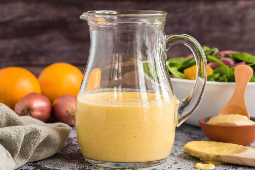 Orange Shallot Vinaigrette in a glass jug on a table