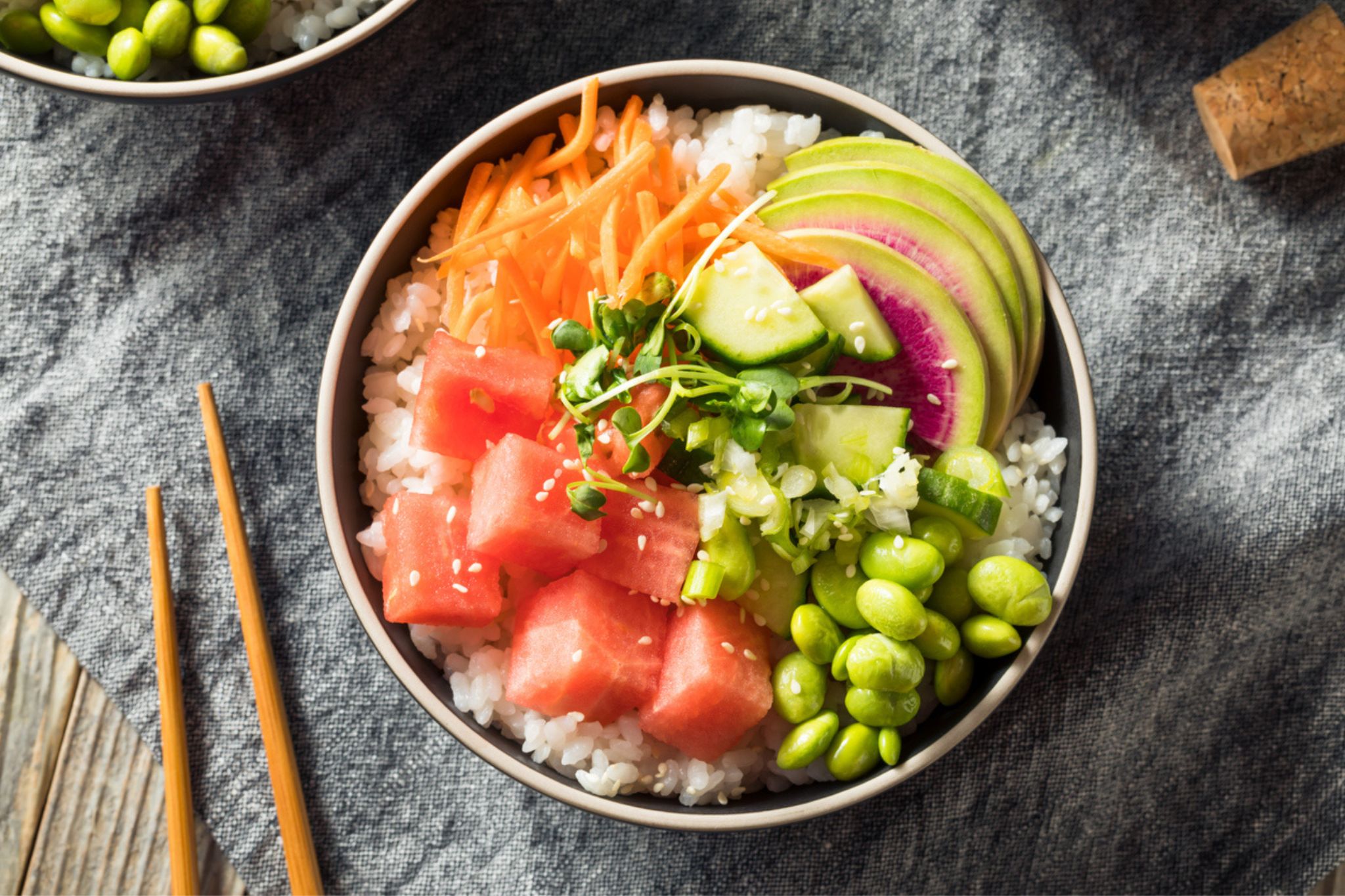 Watermelon Poke in a bowl beside chopsticks