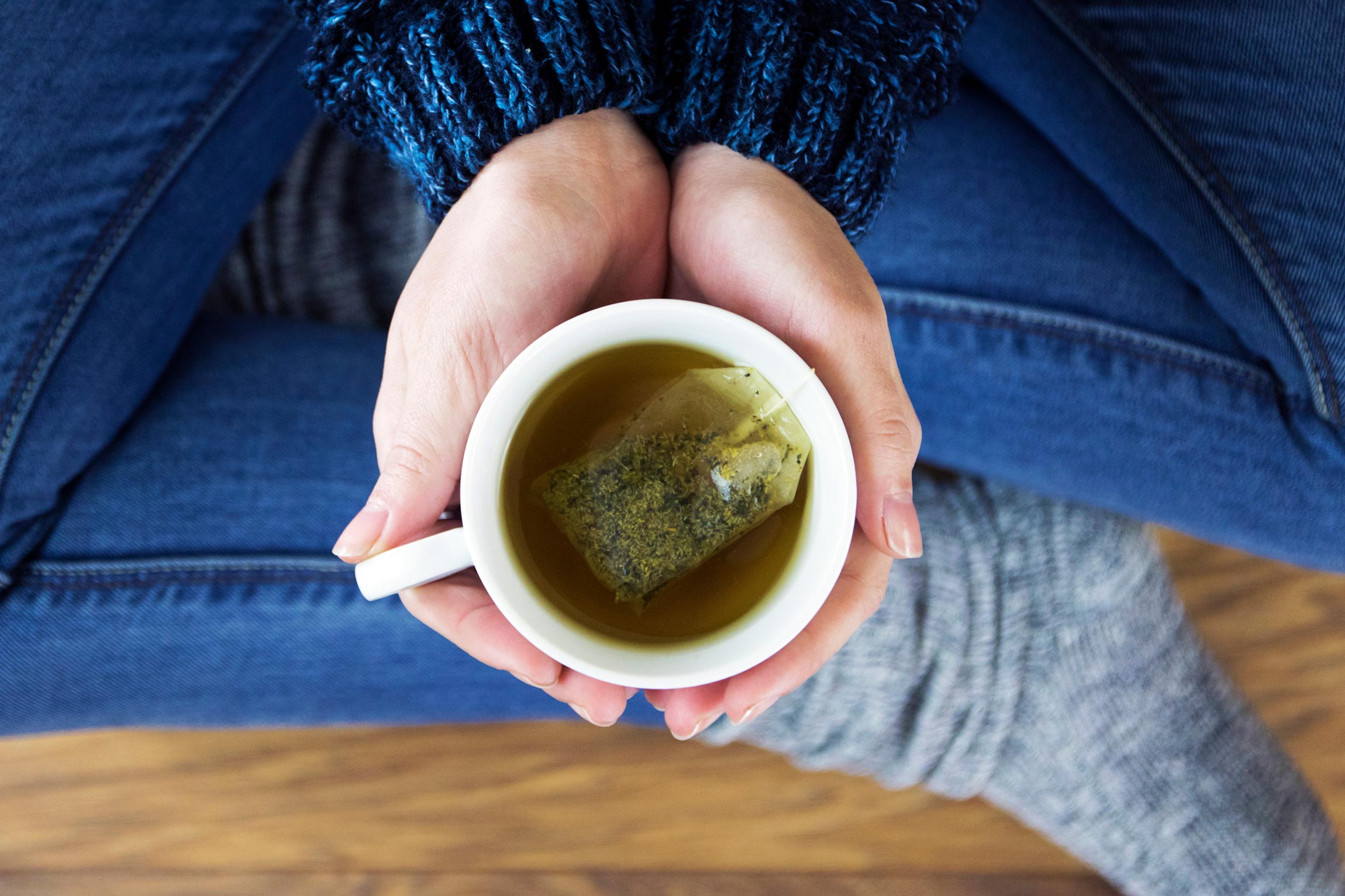 hands holding a cup of tea