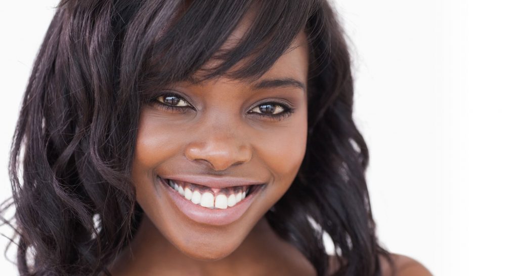 Black woman with clear skin smiling at camera