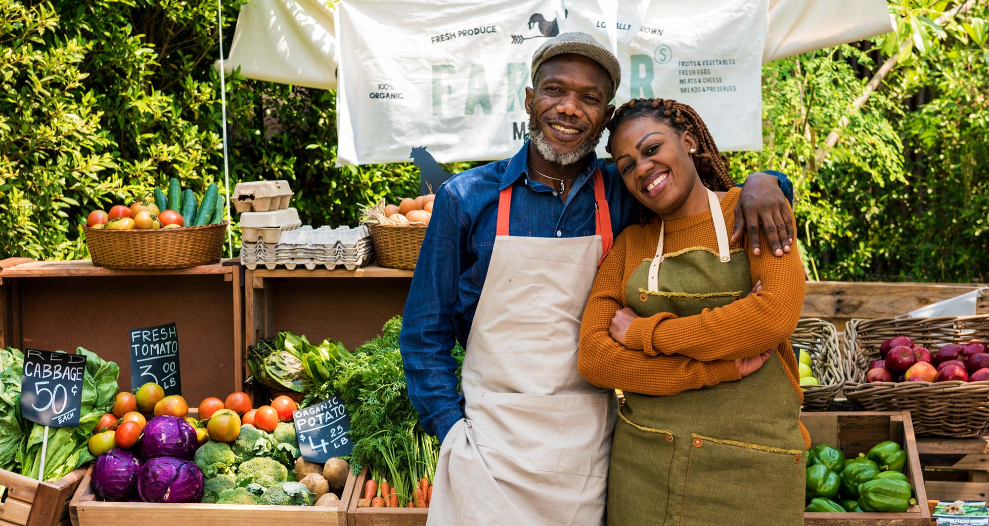 man and woman in front of local food stand