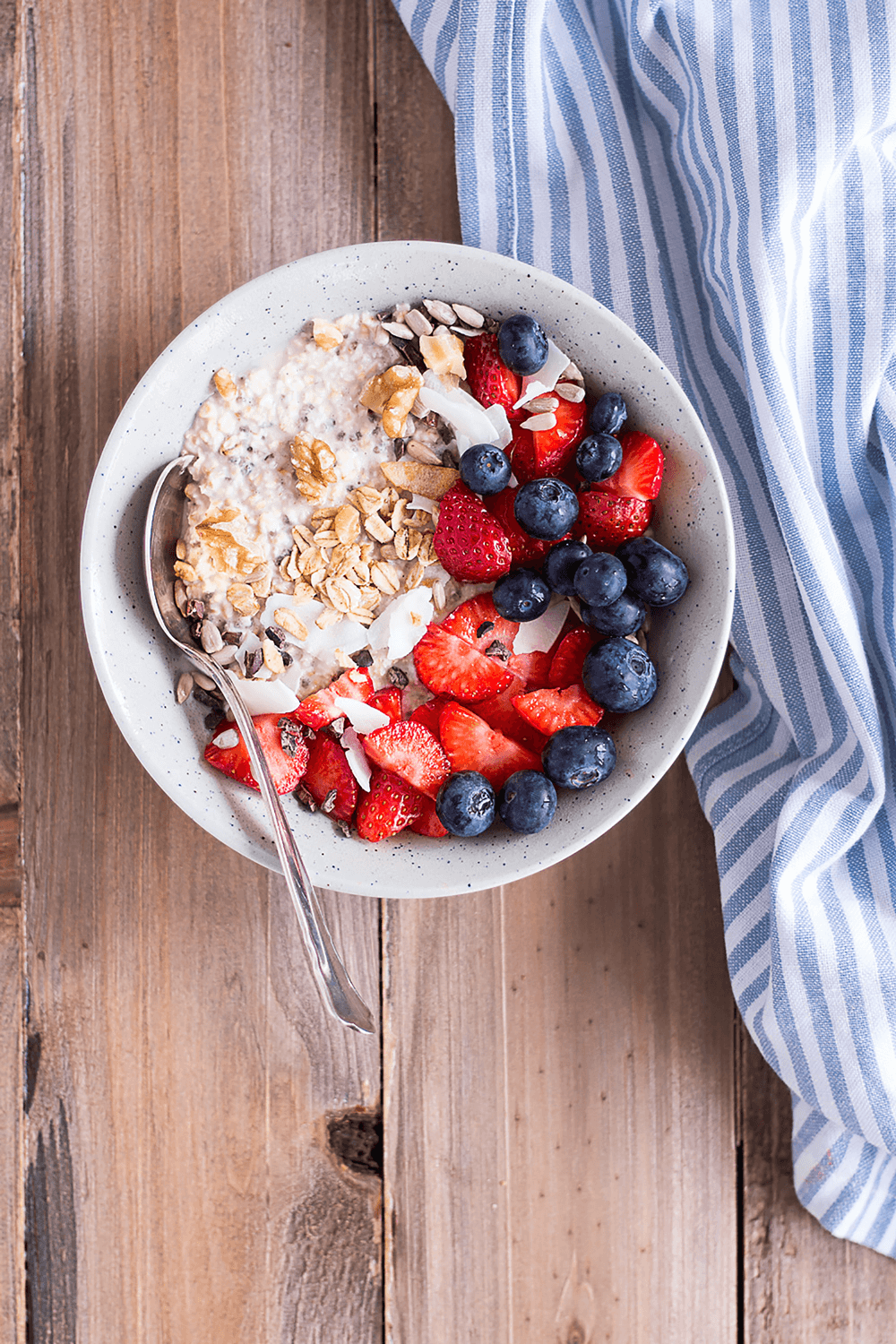 bowl of oats, strawberries, and blueberries