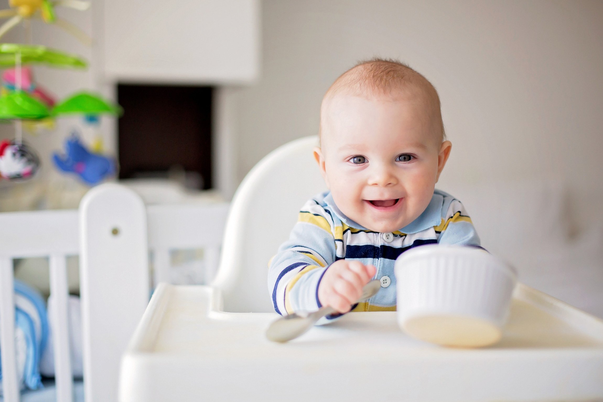 Baby with bowl eating baby food