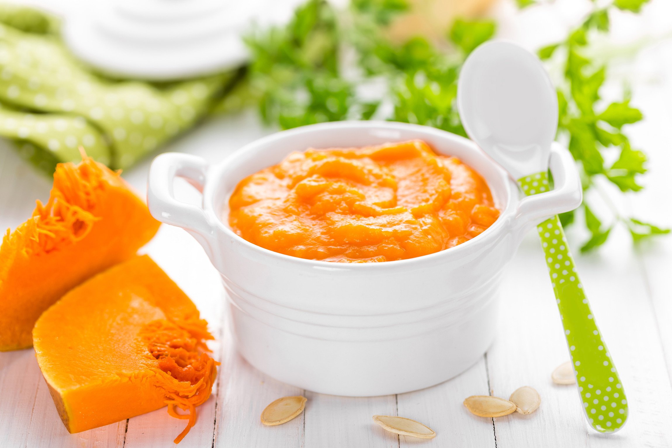 Natural baby food in bowl with spoon