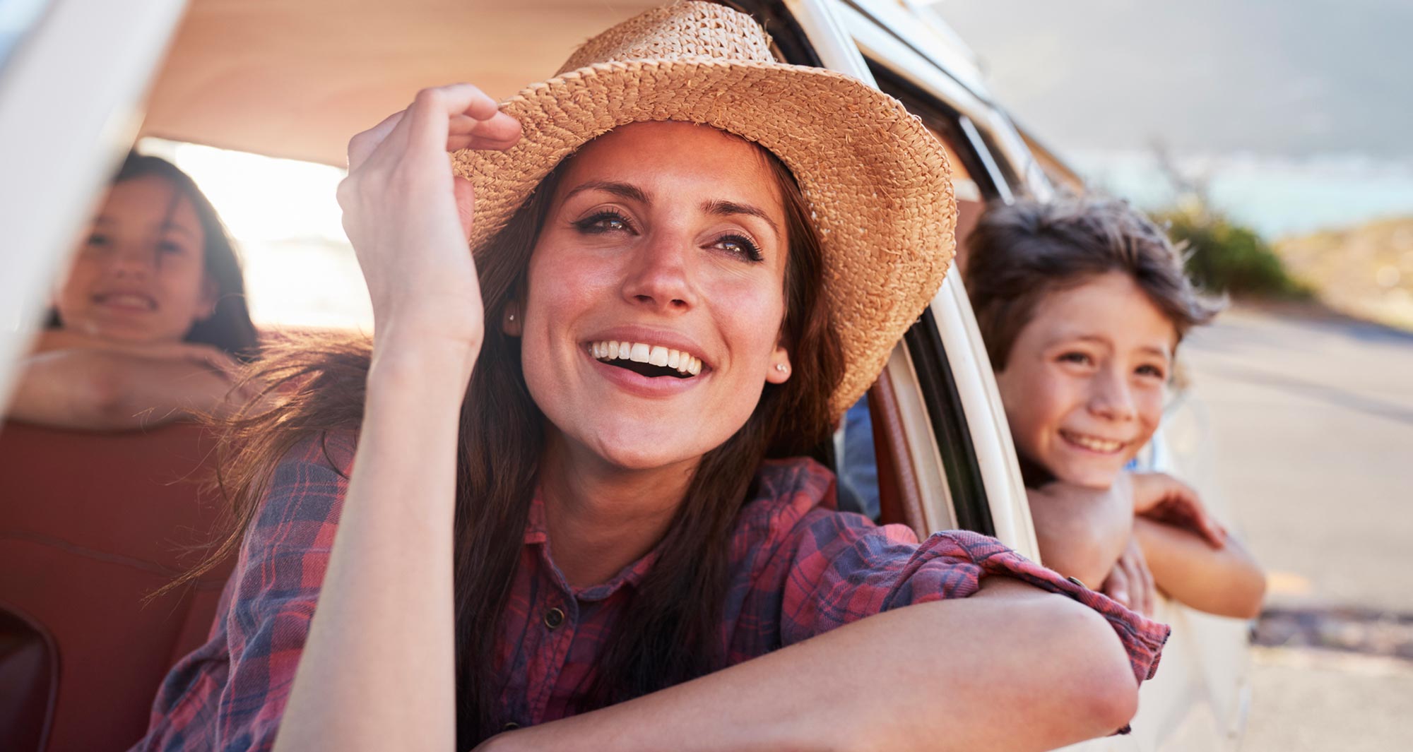 woman and kids looking out the car windows