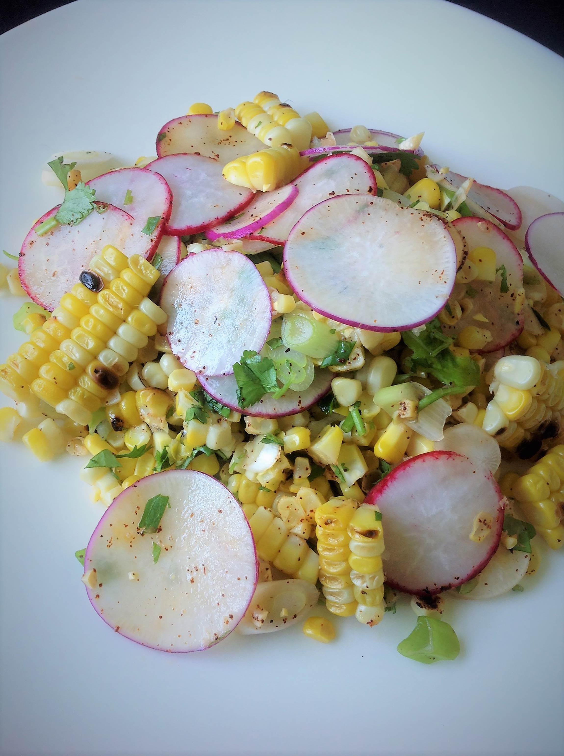 grilled corn and radish salad on a plate