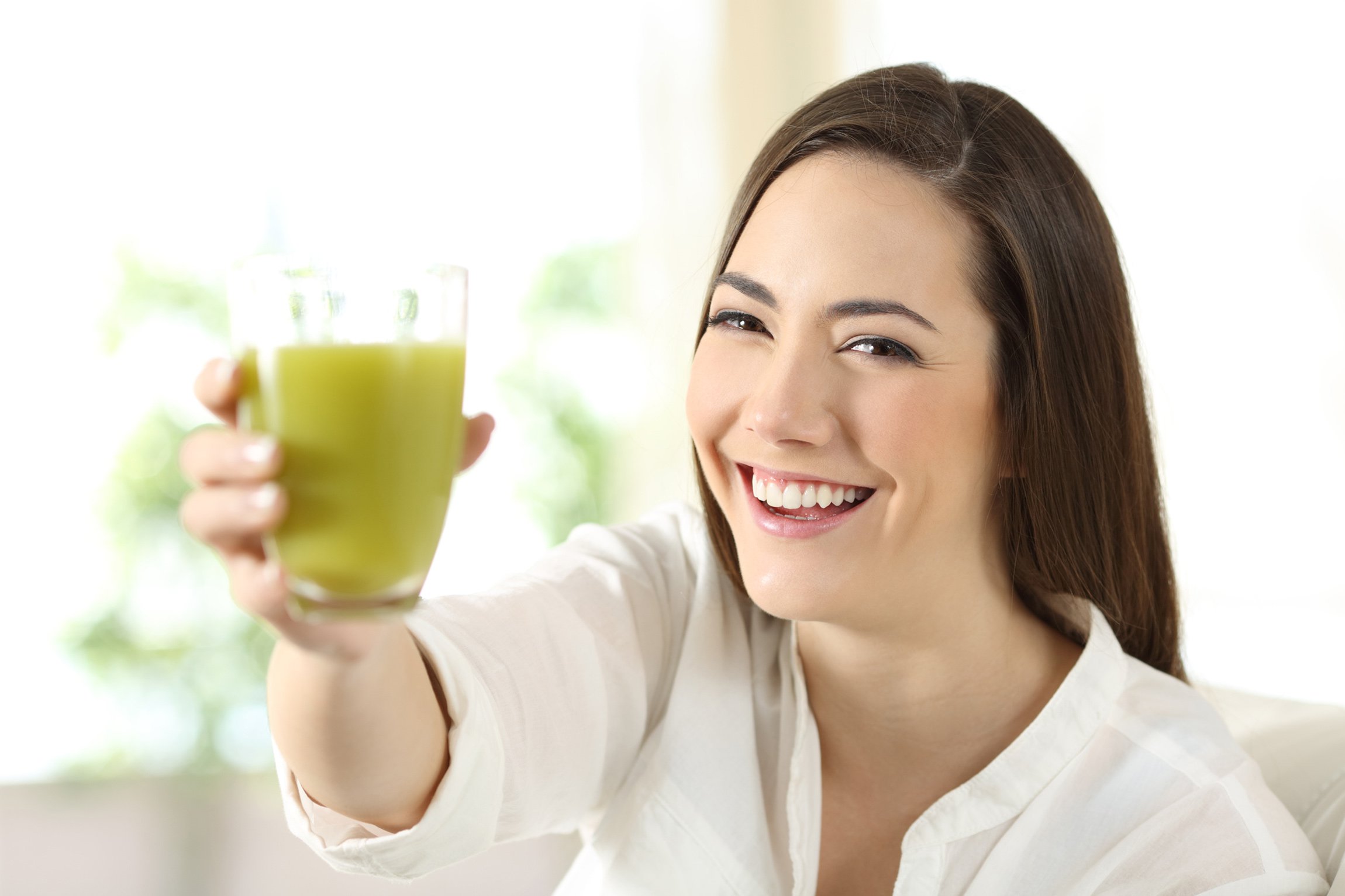 woman with glass of matcha tea