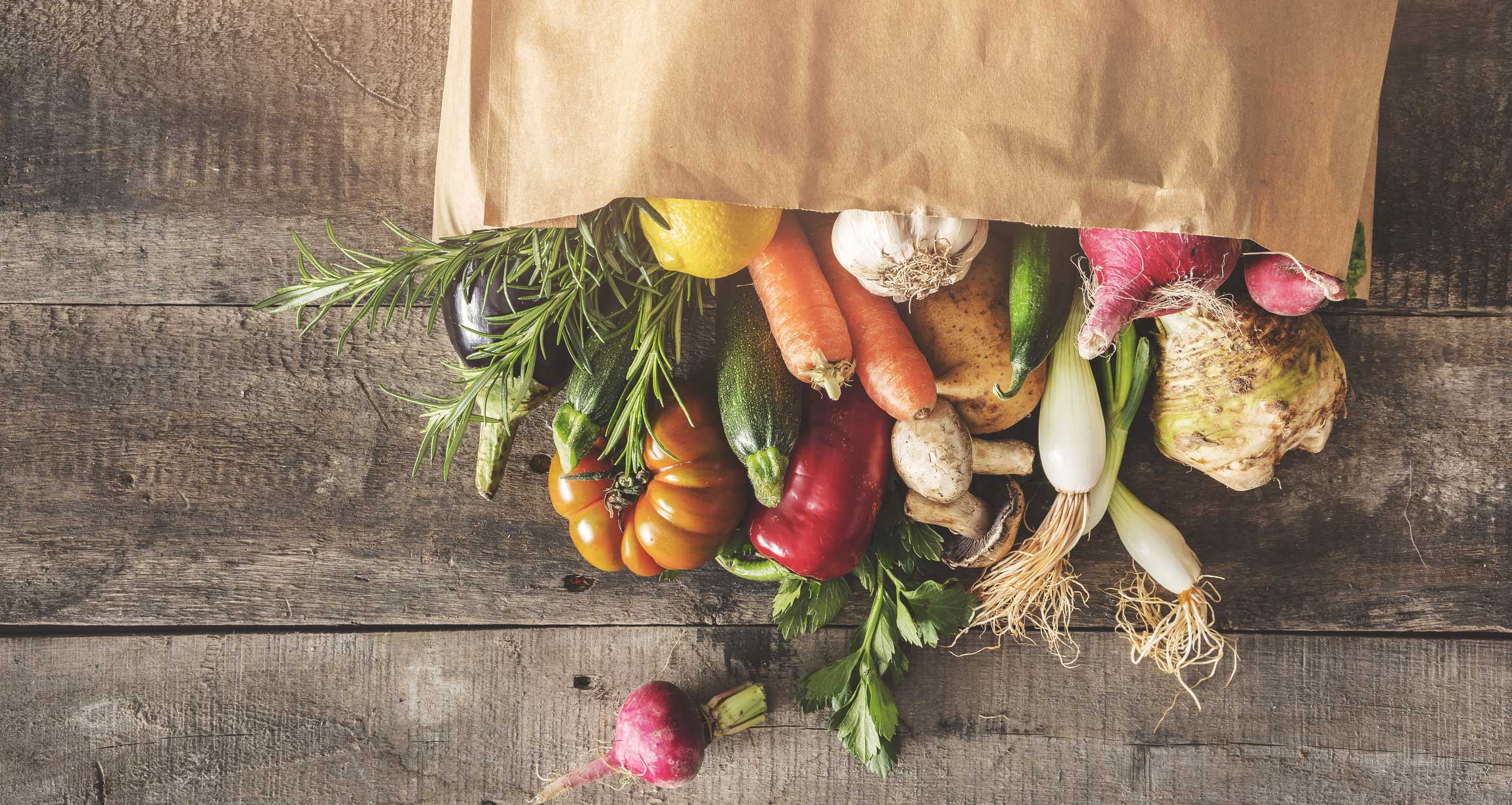 vegetables in a paper bag lying on a table