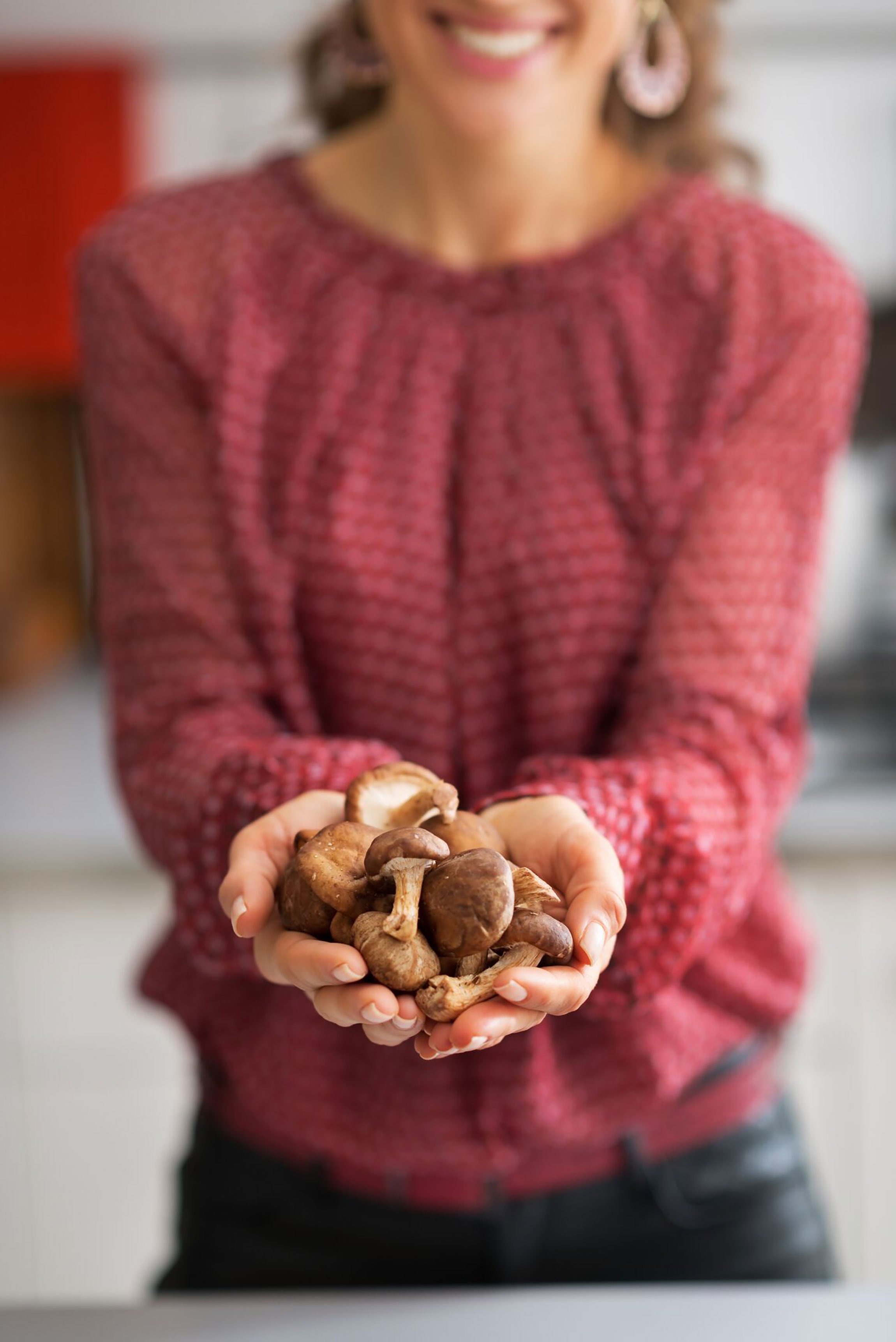 woman holding a handful of mushrooms