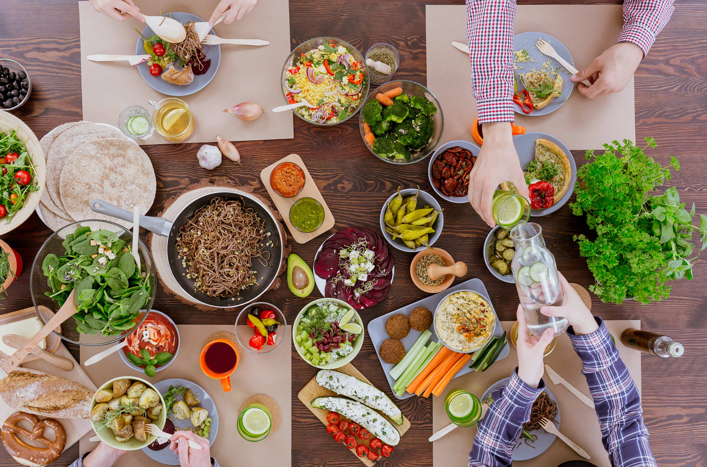 A spread of raw and cooked veggie dishes on a a table