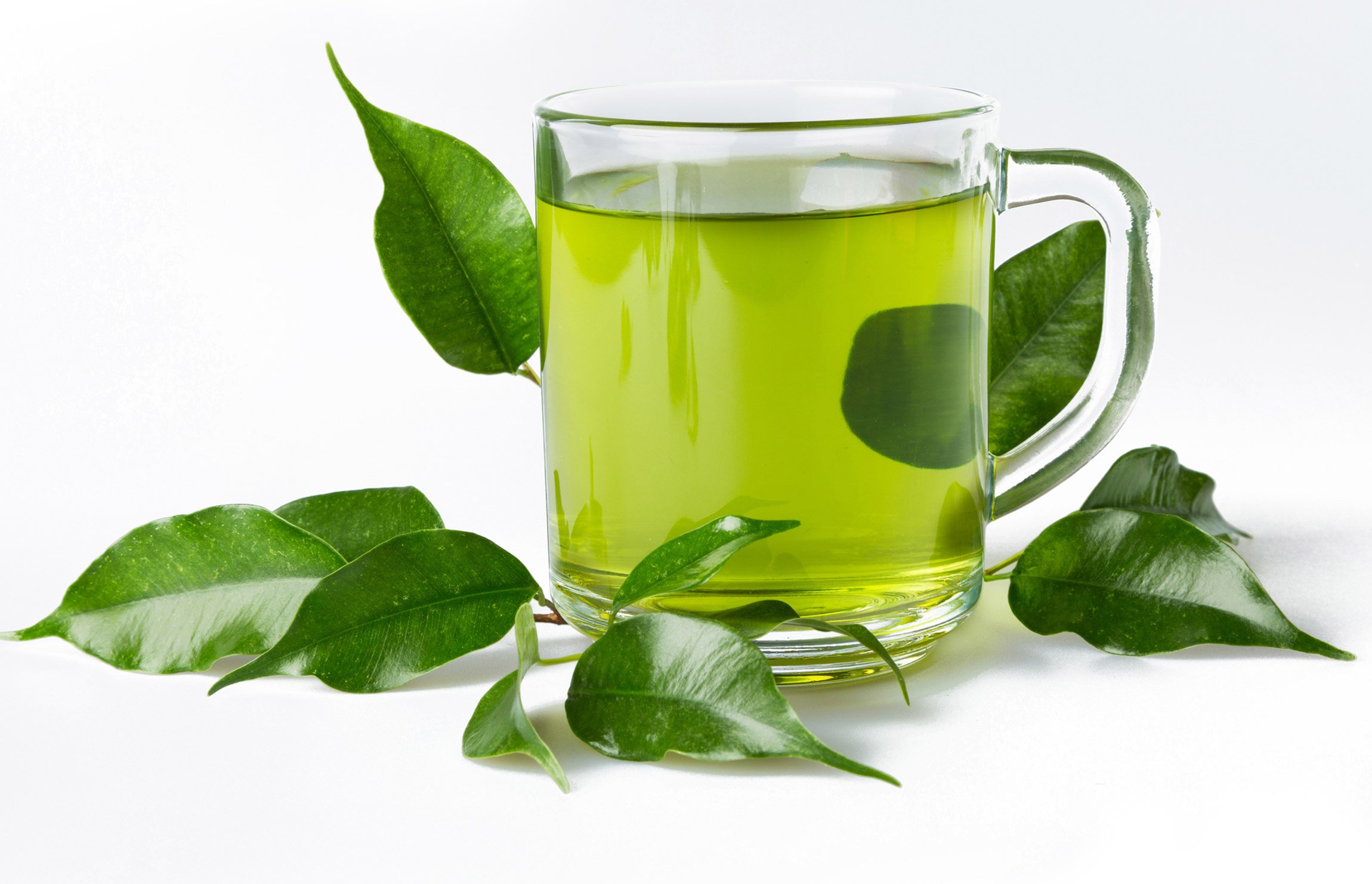 clear glass of green tea with leaves