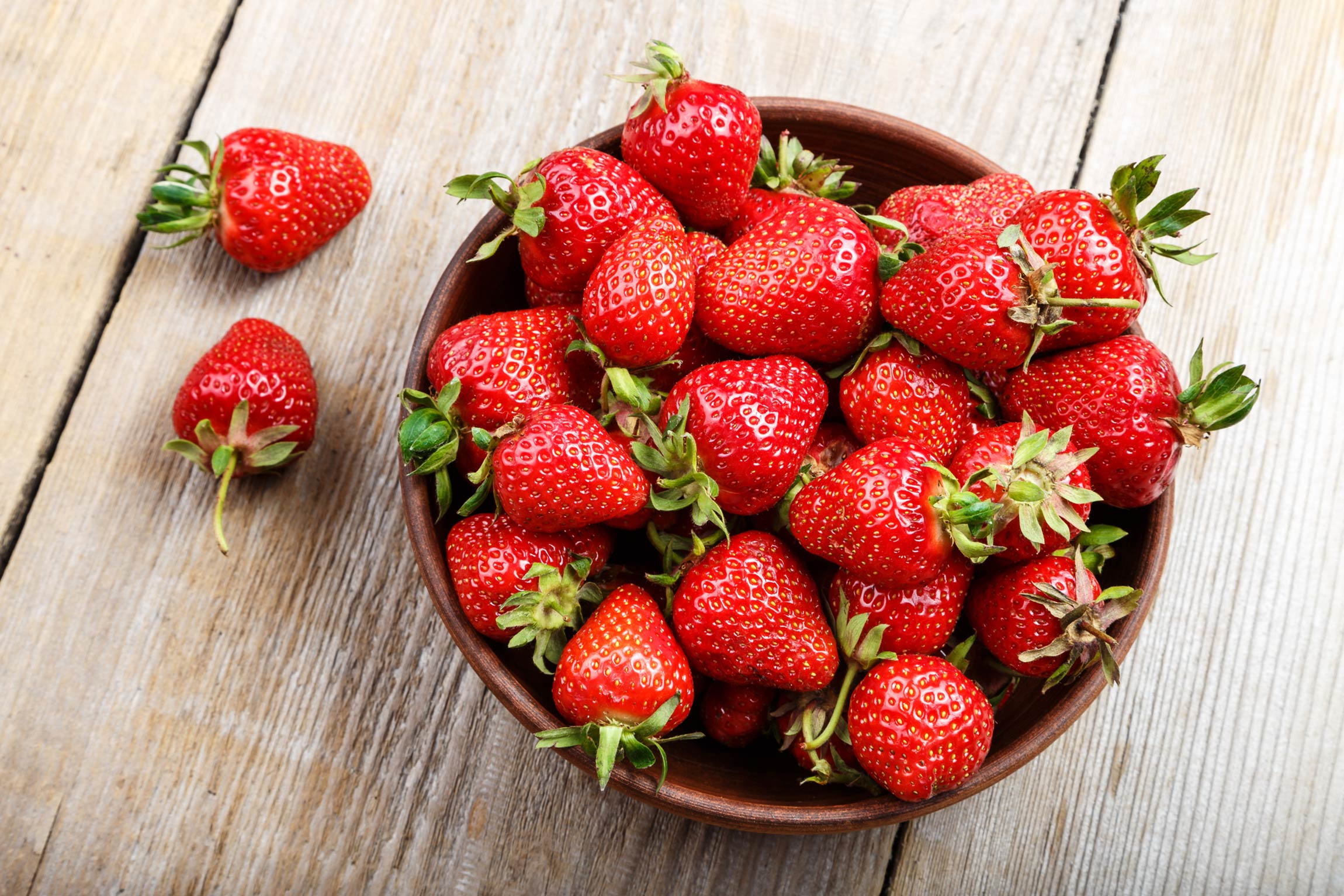 strawberries in a bowl on table