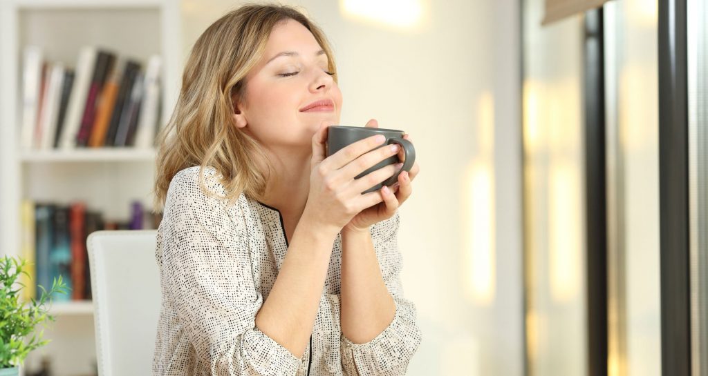 Woman enjoying tea health benefits