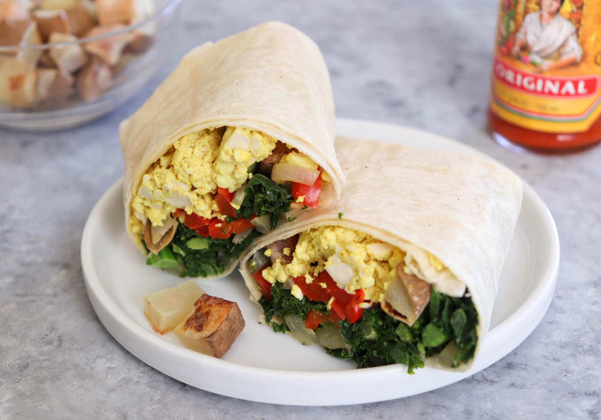 breakfast burrito halved on plate