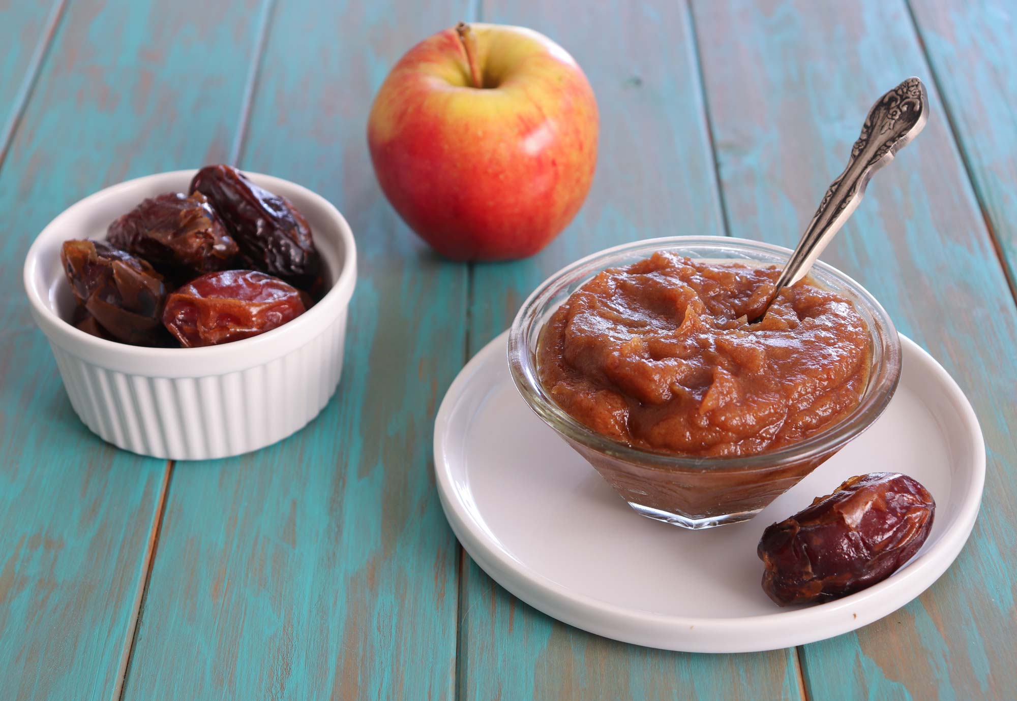 caramel sauce in bowl with apple and dates on side