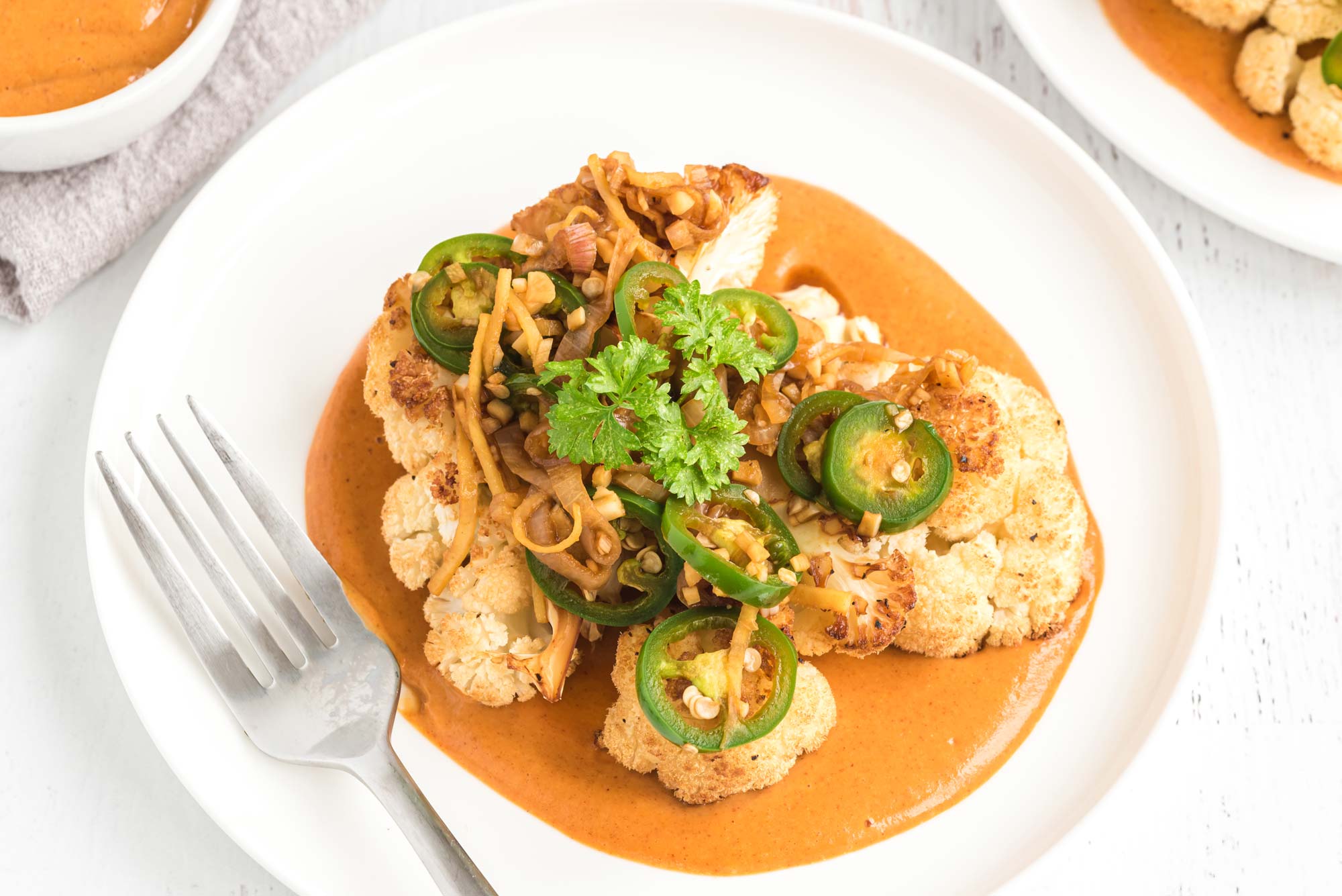 cauliflower steak with peanut sauce on plate