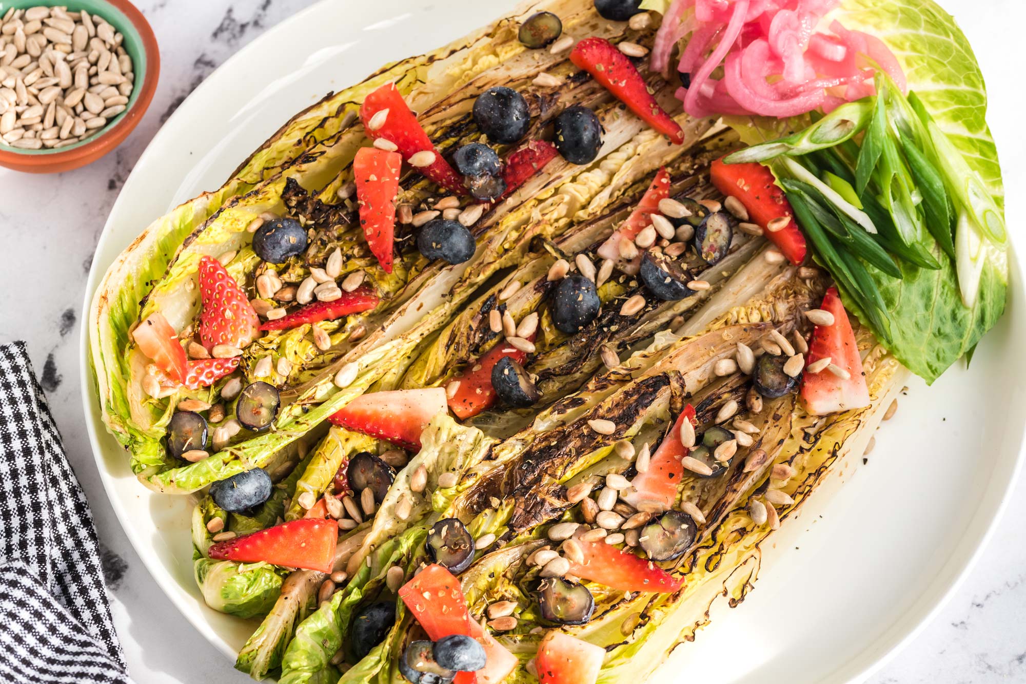 grilled romaine sunflower seed salad on plate