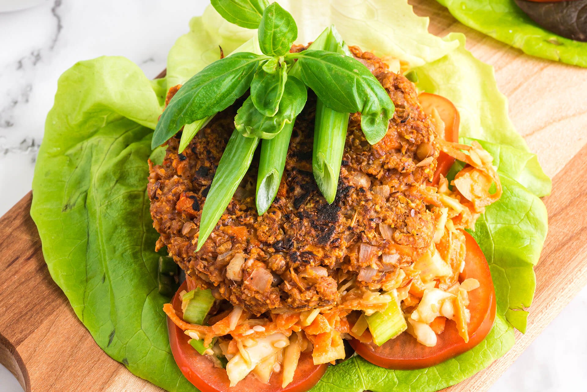 hearty and healing lentil burger on cutting board