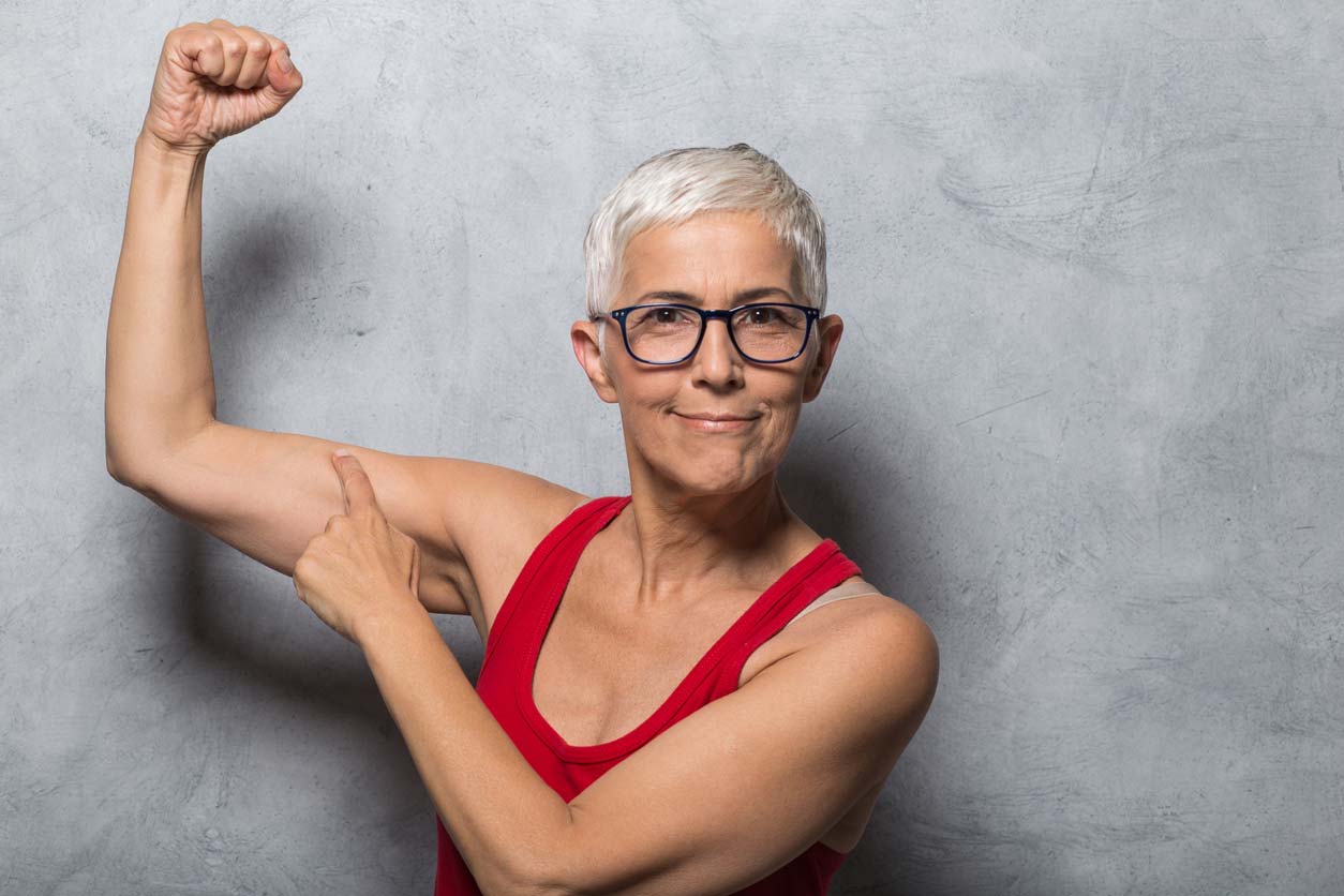 elderly woman showing off her arm muscles