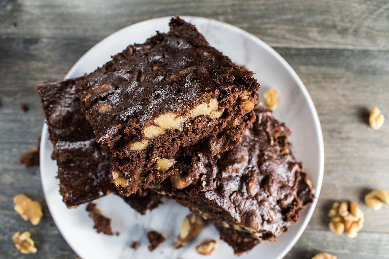 stack of homemade Walnut and chocolate brownies on plate flat lay