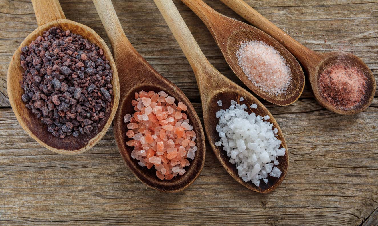 variety salts in wooden spoons