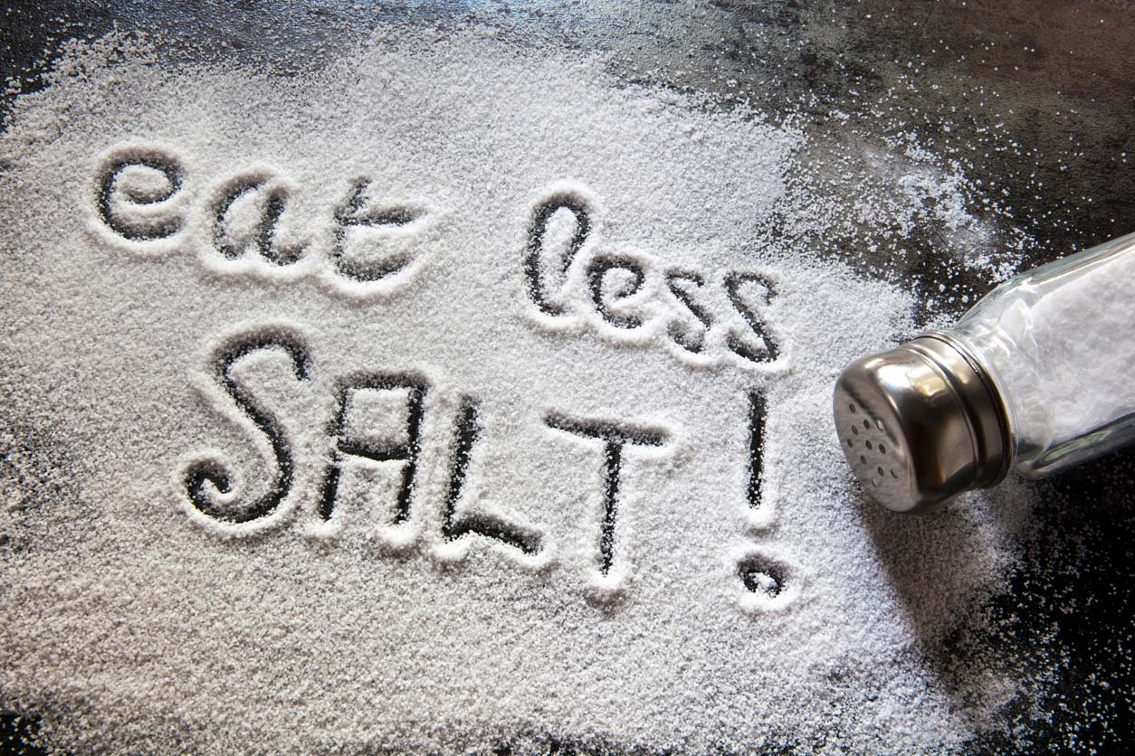 Eat less salt written in salt on table