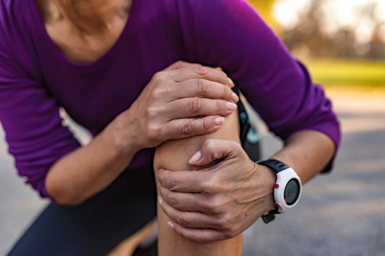 Female runner holding knee