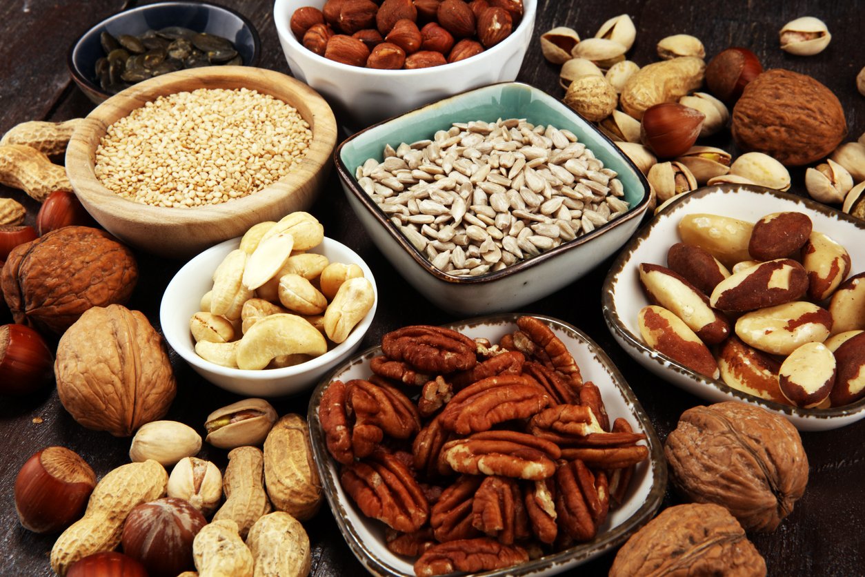 nuts composition on rustic table with walnut and peanut