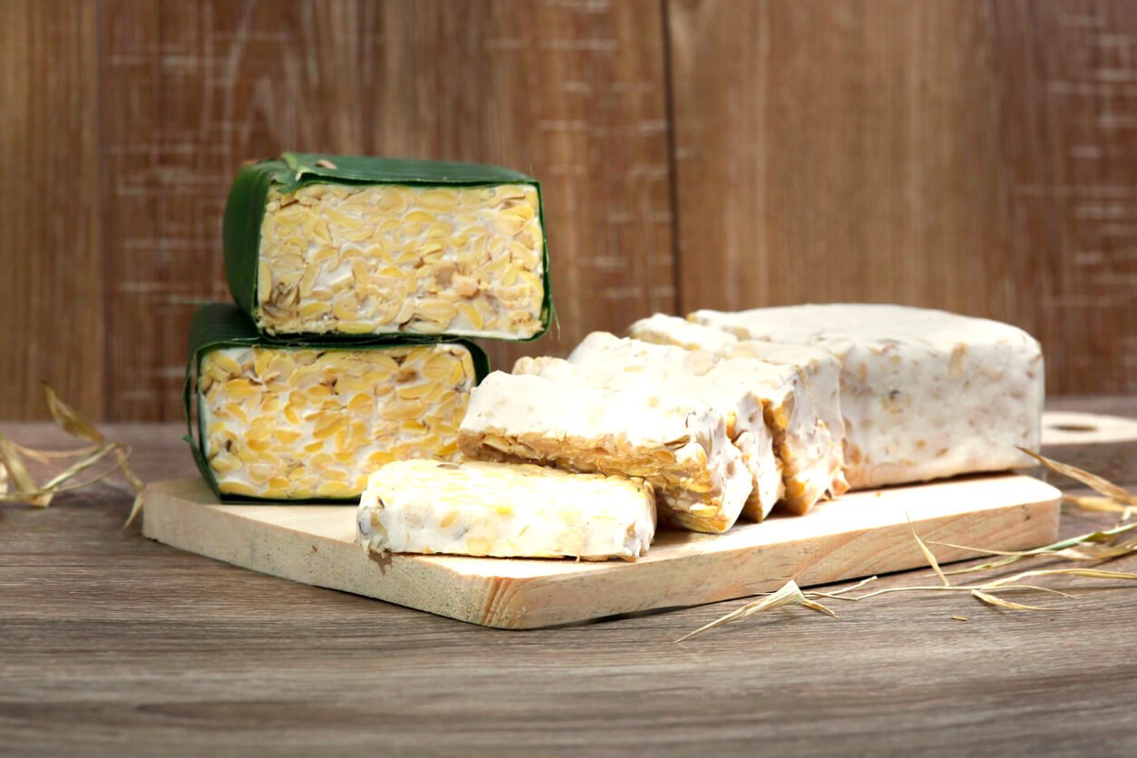 slices of raw tempeh on cutting board