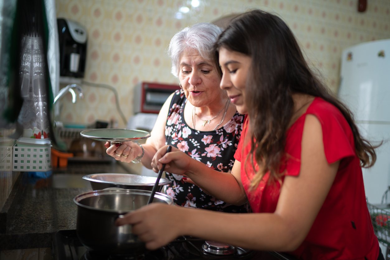 Hispanic women cooking beans in the kitchen