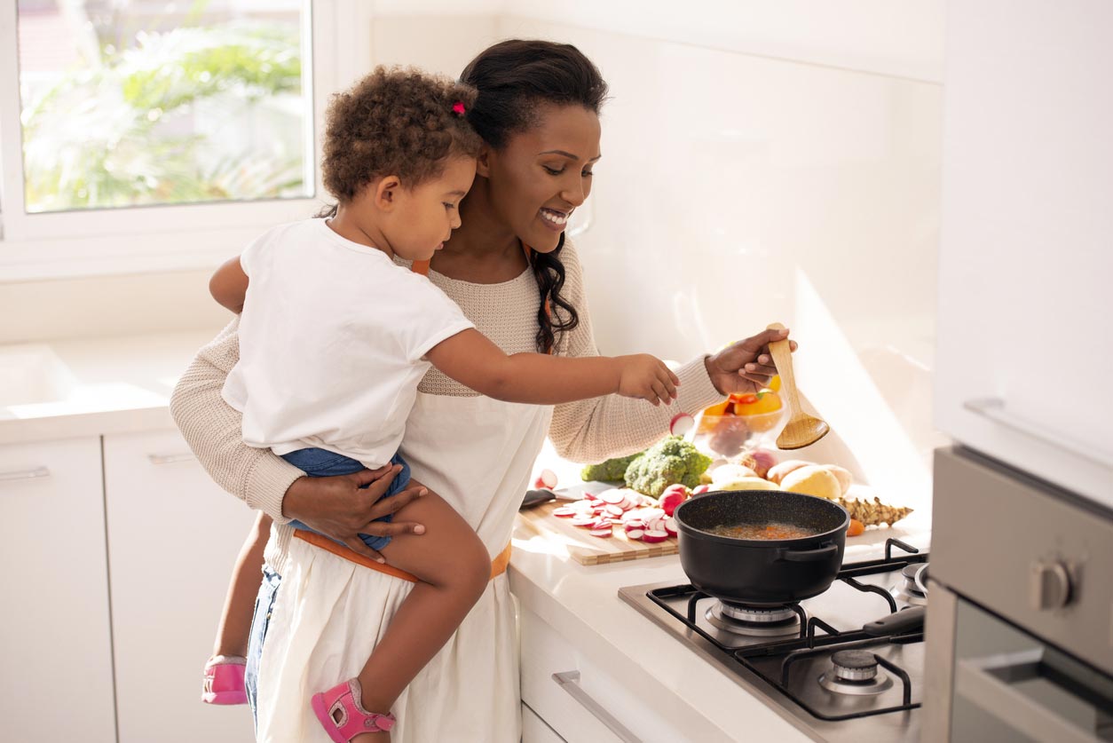 mother and daughter cooking soup