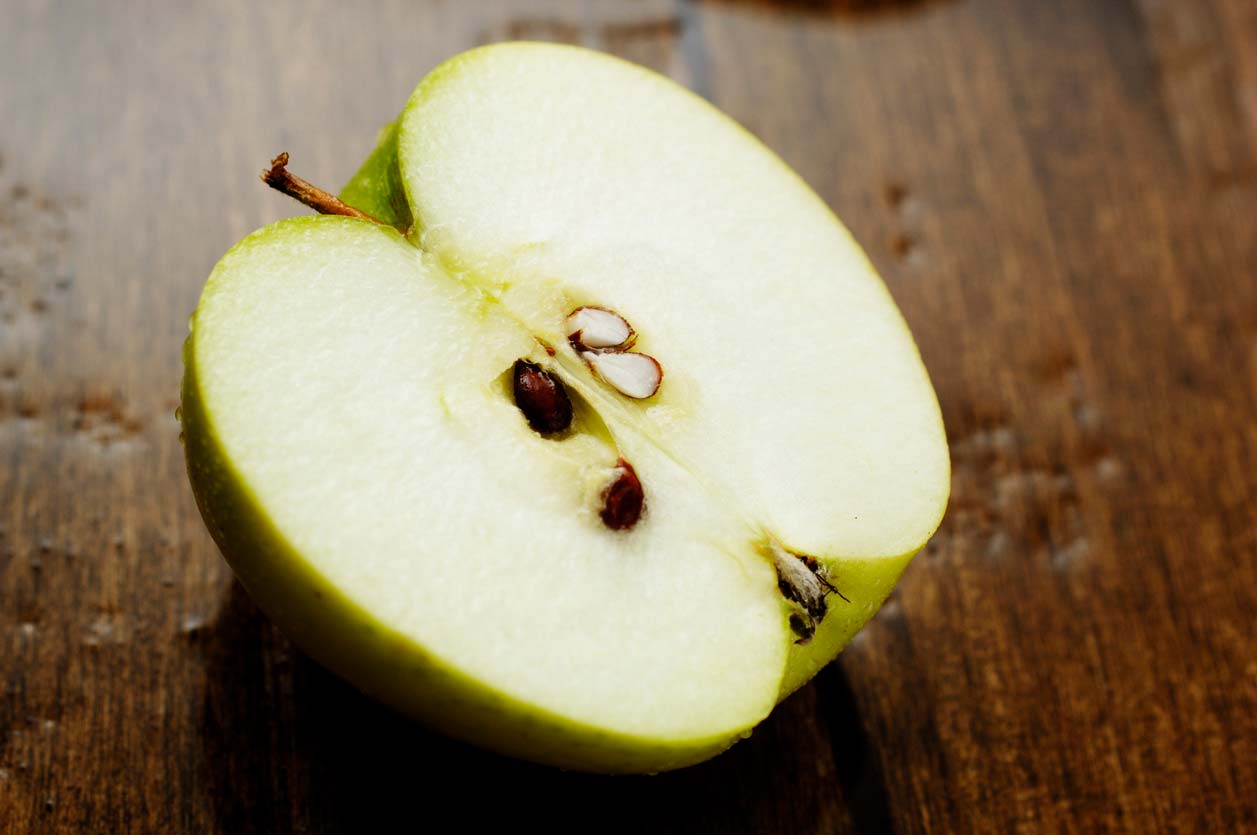 halved apple on table