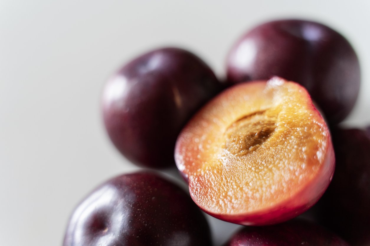 Plums on white background