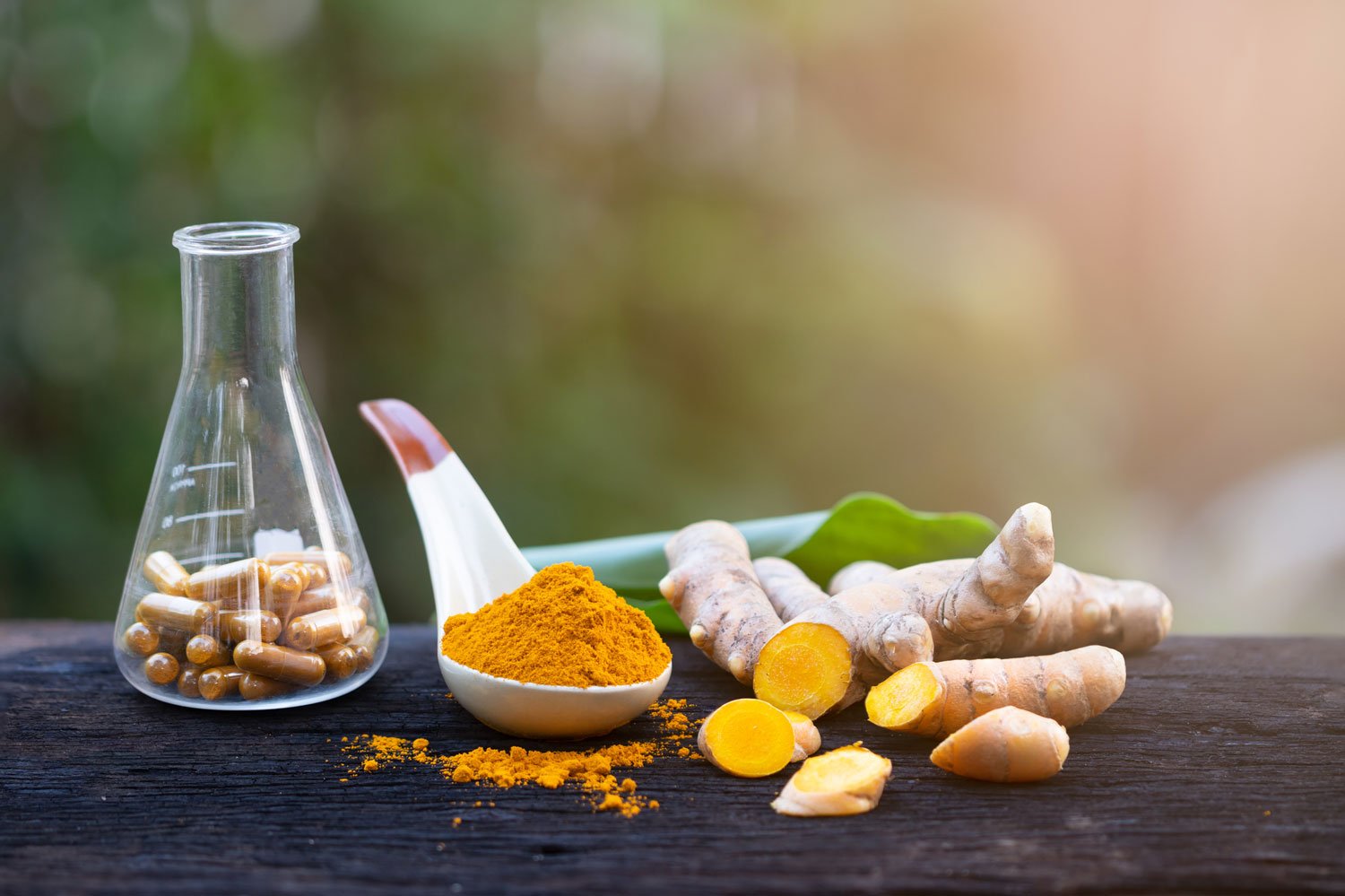 turmeric root and powder in spoon