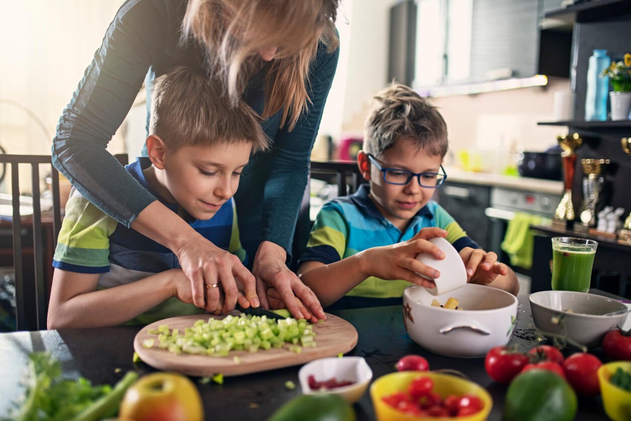 mother and sons making vegan salad at home - focusing on family nutrition