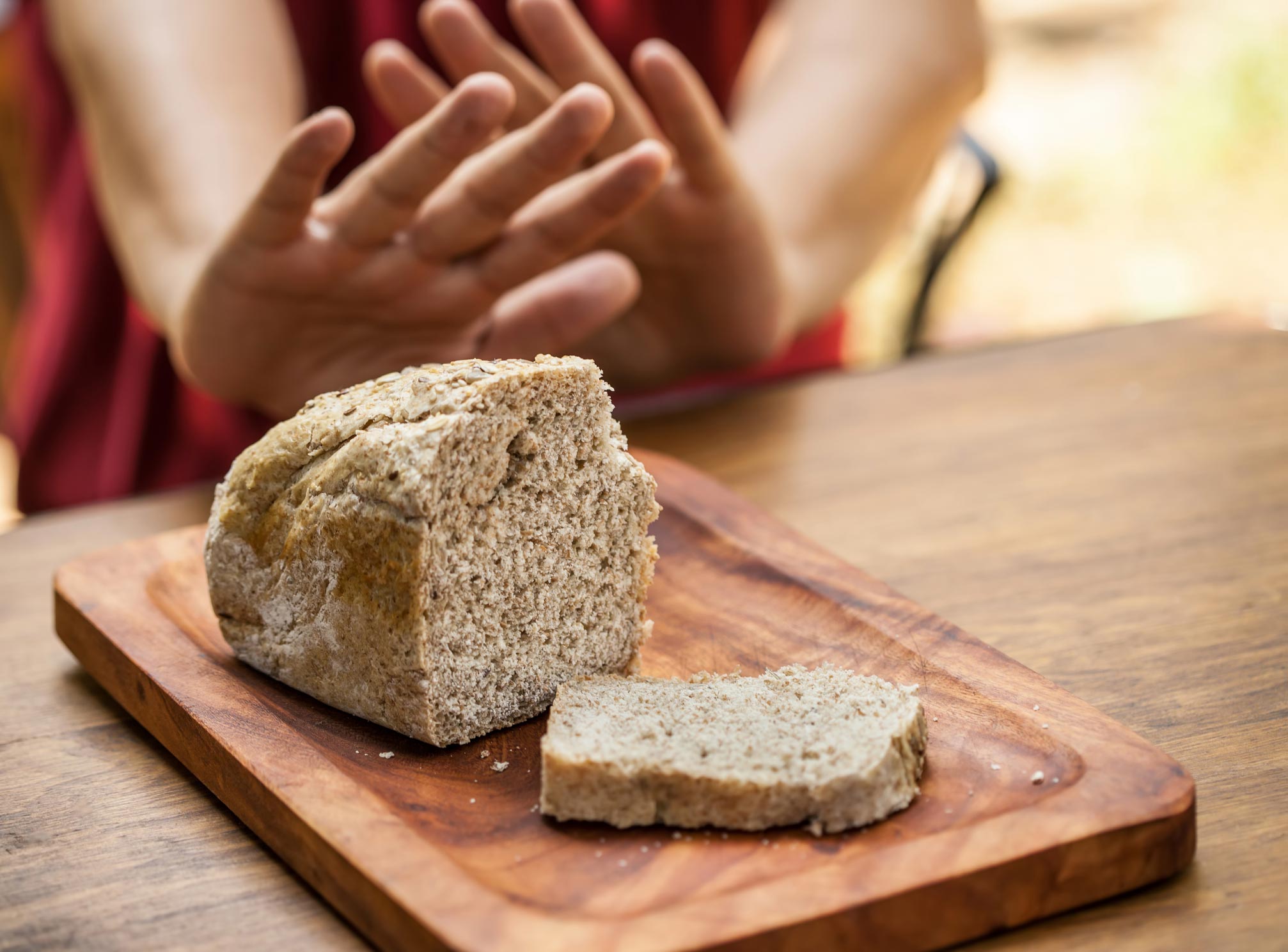 hands motioning no to bread