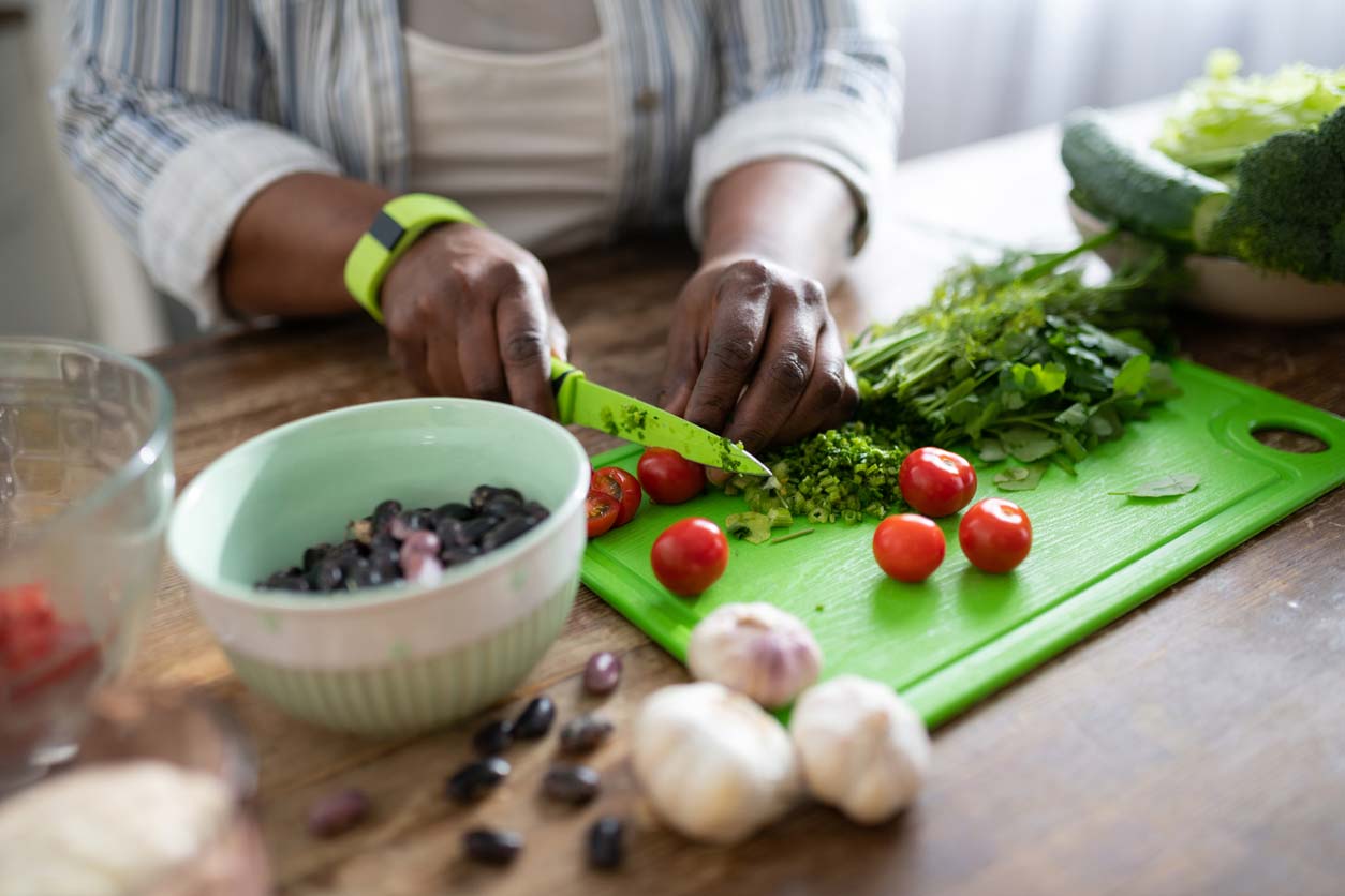 woman of color prepping veggies