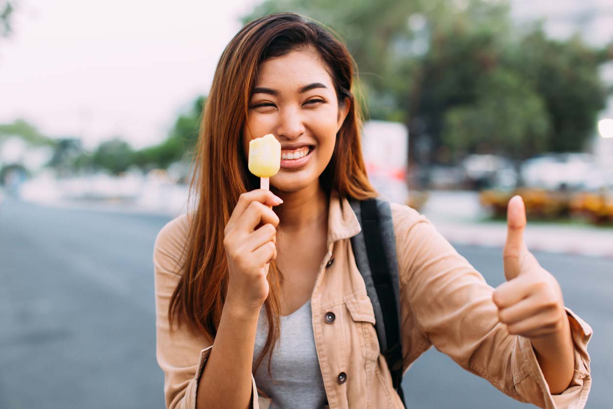 woman enjoying eating a healthy popsicle